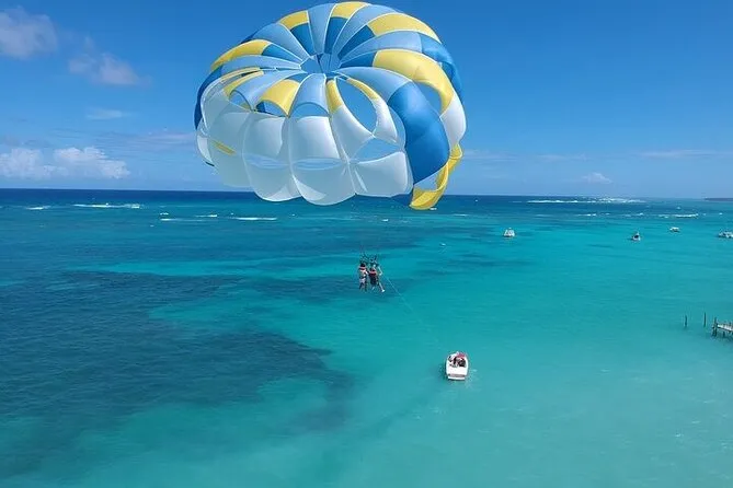 Parasailer soaring above Bávaro Beach coral reef on the Sky High Thrills parasailing experience in Punta Cana Dominican Republic with SeaPro Divers